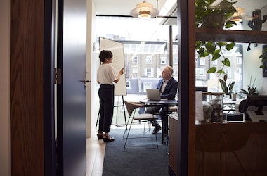 brown office man and woman meeting